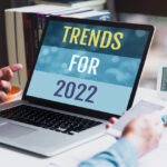 marketing trends in 2022 concept; businessman using laptop showing words trends for 2022