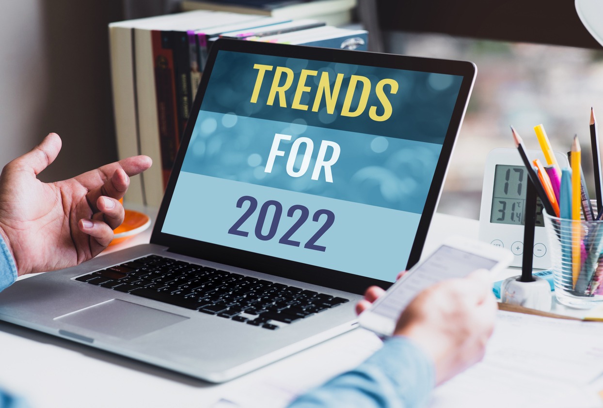 marketing trends in 2022 concept; businessman using laptop showing words trends for 2022